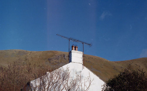 Low angle view of mountain against blue sky