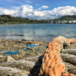 Close-up of rocks on shore against sky