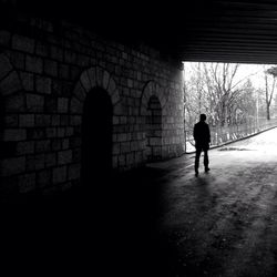 Full length of woman walking in tunnel