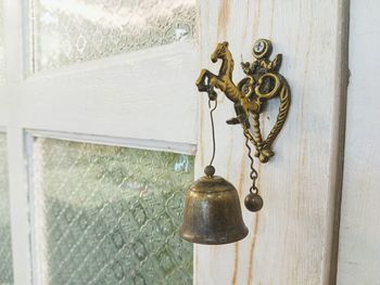 Close-up of bell hanging on wall