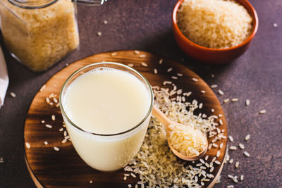 Alternative healthy rice milk in a glass and rice cereal on the table