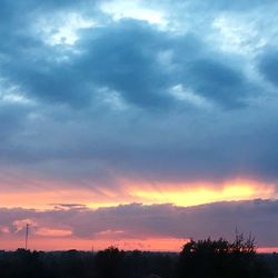 Silhouette trees against sky during sunset