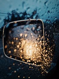 Close-up of wet car on road