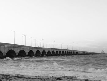 Bridge over sea against sky