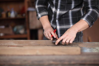 Midsection of man working on table