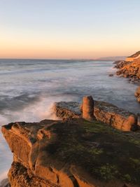 Scenic view of sea against clear sky during sunset