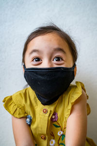 Asian young child is wearing hygienic reusable face mask to prevent the virus. new normal.