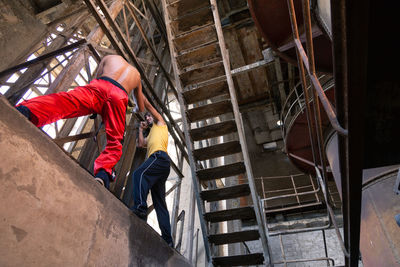 High angle view of man working on staircase