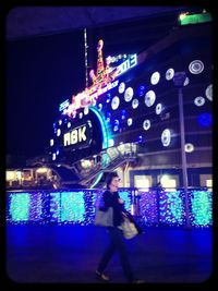 Woman in city at night