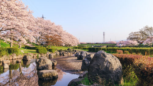 Panoramic shot of rocks by river against sky