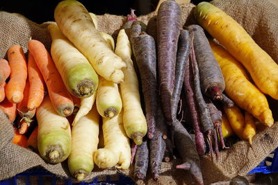 Orange, purple, white, and yellow organic carrots