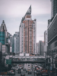 View of city street and buildings against sky