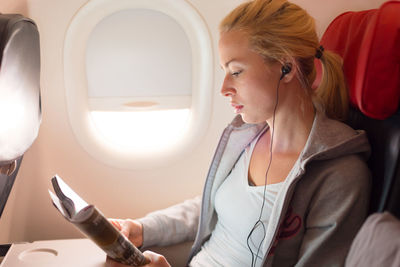 High angle view of businesswoman sitting in plane