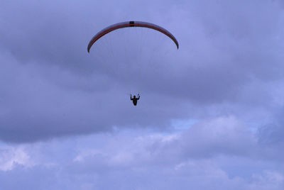 Low angle view of helicopter flying against sky