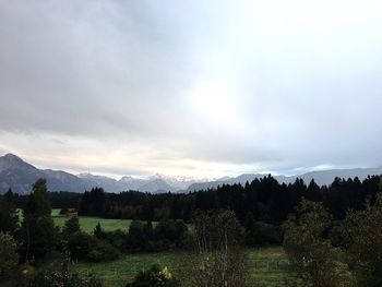 Countryside landscape against mountain range