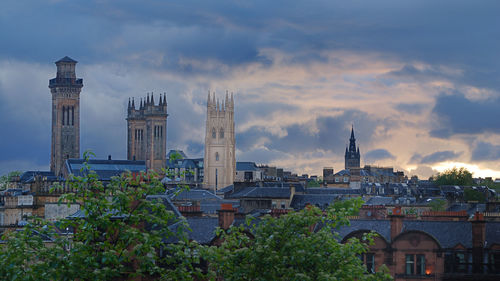 View of cityscape against cloudy sky