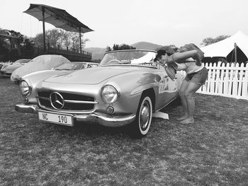 Woman in car against sky