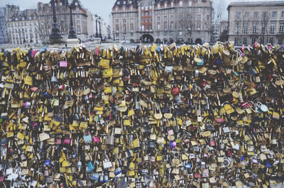 Padlocks hanging on railing in city