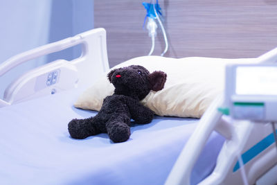 High angle view of teddy bear on bed in hospital