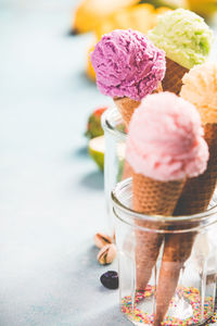 Close-up of ice cream cones in containers on table