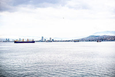 City view of izmir from the ferryboat. cold grey winter aegean sea.