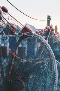 Close-up of fishing net hanging on rope