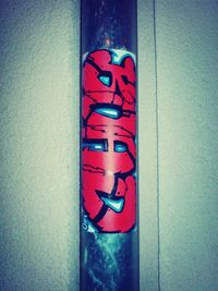 Close-up of illuminated text on blue wall