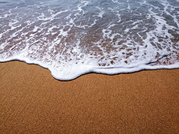 High angle view of surf on beach