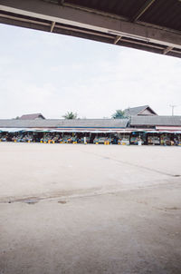 View of airport runway by building against sky