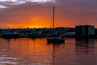 Boats in marina at sunset