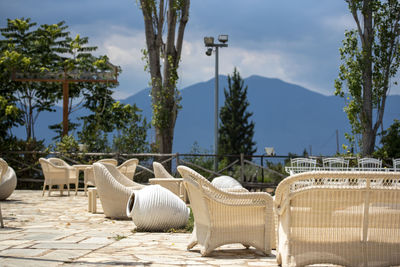 Empty chairs and tables at outdoor cafe