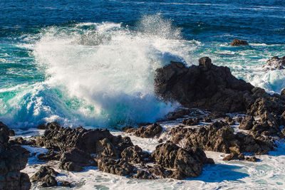 Waves splashing on rocks at shore