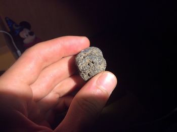 Close-up of person hand holding rock