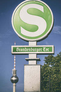 Low angle view of road sign against sky