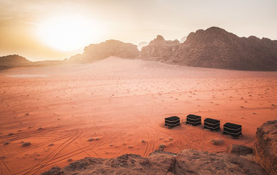 Scenic view of desert against sky during sunset