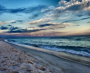 Scenic view of beach against sky during sunset