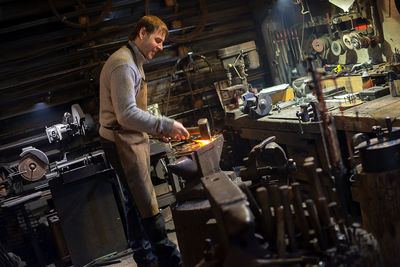 Blacksmith working in workshop