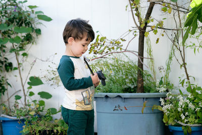 Boy playing with a stick in the garden