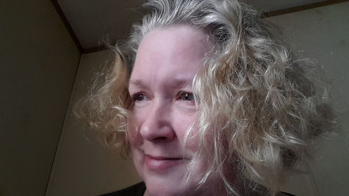 Close-up portrait of woman at home