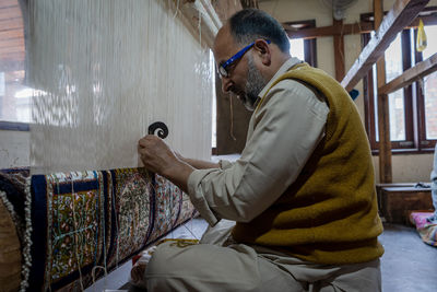 Side view of man using mobile phone