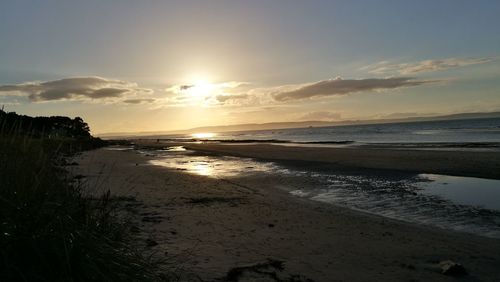 Scenic view of beach against sky during sunset