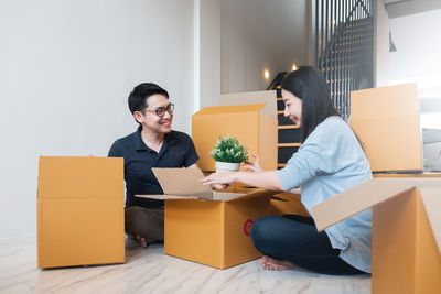 Young couple sitting in box