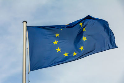 Eu, europe, european union flag waving on blue sky background