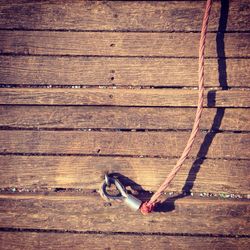 High angle view of rope tied up to cleat on dock