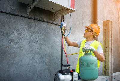 Worker repairing air conditioner