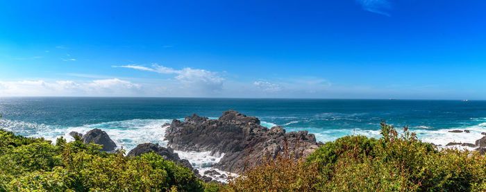 Scenic view of sea against blue sky