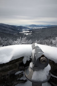 Close-up of snow on landscape against mountain