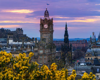 Low angle view of buildings against sky during sunset