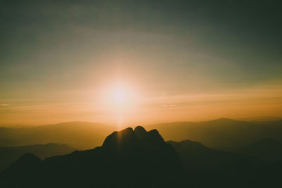 Scenic view of silhouette mountains against sky during sunset