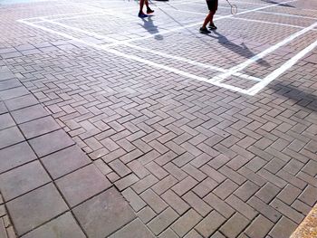 Low section of people walking on footpath